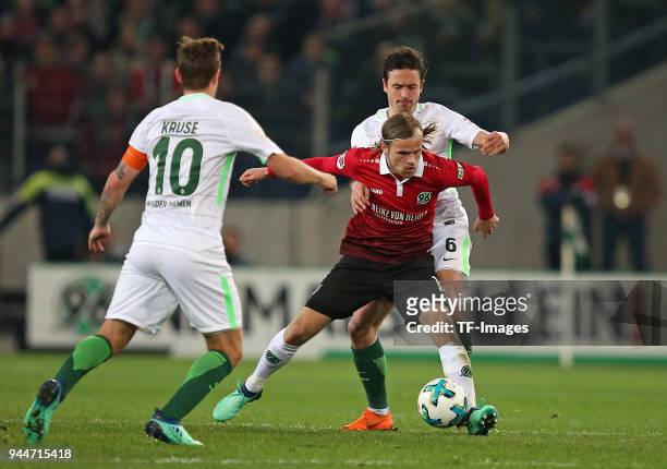 Max Kruse of Bremen, Iver Fossum of Hannover and Thomas Delaney of Bremen battle for the ball during the Bundesliga match between Hannover 96 and...