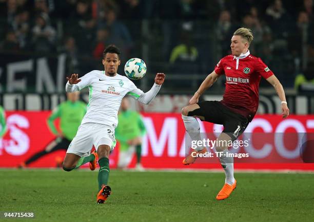 Theodor Gebre Selassie of Bremen and Felix Klaus of Hannover battle for the ball during the Bundesliga match between Hannover 96 and Werder Bremen at...