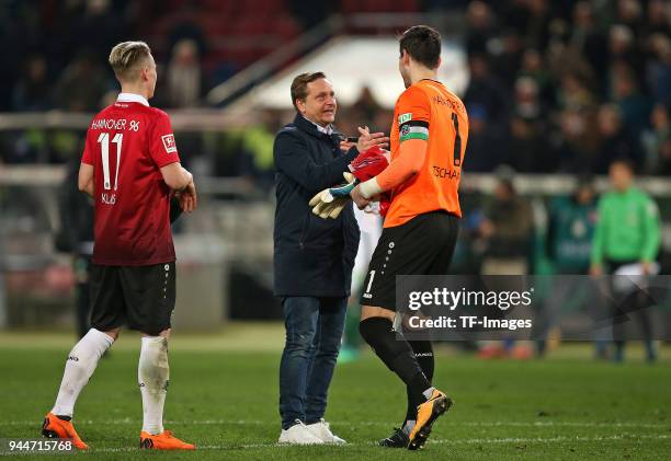 Felix Klaus of Hannover, Horst Heldt of Hannover and Goalkeeper Philipp Tschauner of Hannover gesture during the Bundesliga match between Hannover 96...