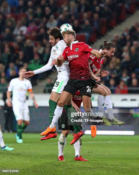 Ishak Belfodil of Bremen, Niclas Fuellkrug of Hannover and Martin Harnik of Hannover battle for the ball during the Bundesliga match between Hannover...