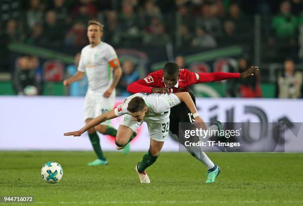 Marco Friedl of Bremen and Ihlas Bebou of Hannover battle for the ball during the Bundesliga match between Hannover 96 and Werder Bremen at HDI Arena...
