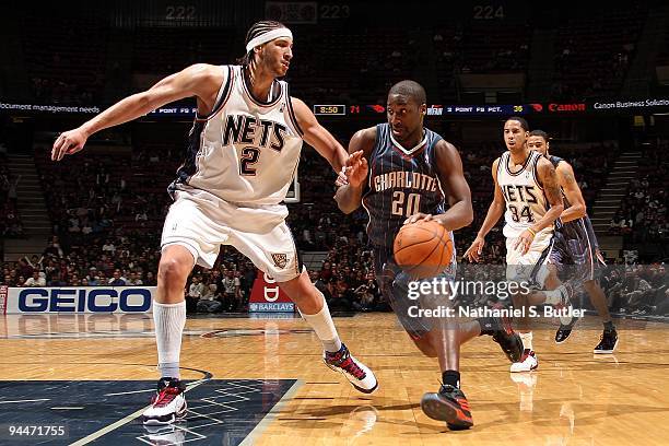 Raymond Felton of the Charlotte Bobcats drives to the basket against Josh Boone of the New Jersey Nets during the game on December 4, 2009 at the...