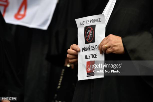 Lawyer holds a placard reading 'Private justice : stripped of justice'. The French Bar Association, all lawyers' unions, all magistrates' unions...
