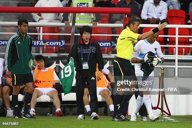 Referee Roberto Rosetti of Italy sends Denilson of Pohang Steelers into the goal after changing the goalkeeper's gloves during the FIFA Club World...