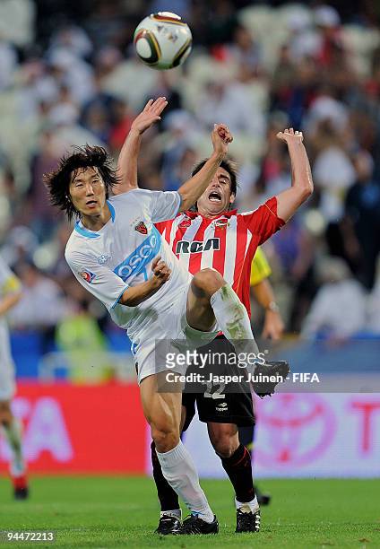 Rodrigo Brana of Estudiantes duels for the ball with Jae Sung Kim of Pohang Steelers during the FIFA Club World Cup semi-final match between Pohang...