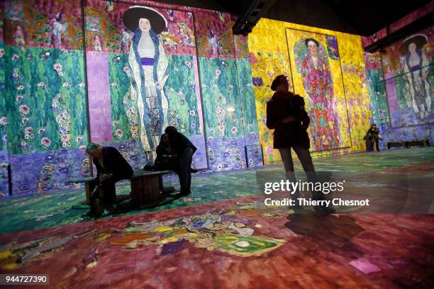 Visitors attend a press preview of the immersive exhibition "Klimt Hundertwasser Poetic_Ai" that pays tribute to Austrian artist Gustav Klimt at the...