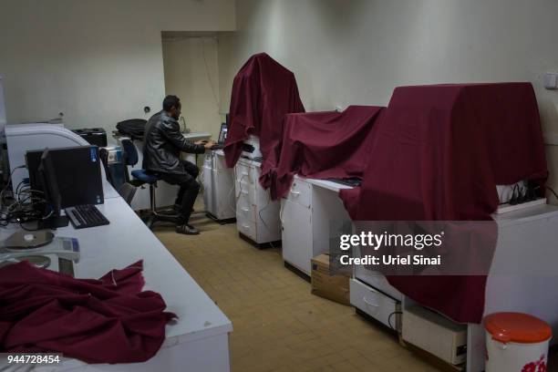 Student works on his computer as state of the art biomedical laboratory .equipment sits unplugged and covered with sheets at the Addis Ababa...