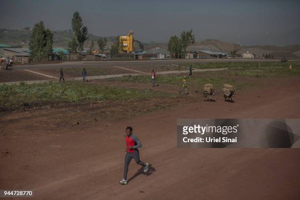 Kenenisa Bekele runs during a training at a highway under construction on September 26, 2015. In Kalite, Ethiopia. ..