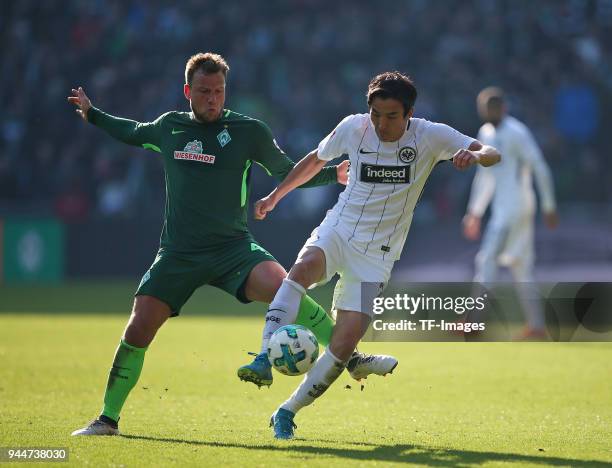 Philipp Bargfrede of Bremen and Makoto Hasebe of Frankfurt battle for the ball during the Bundesliga match between Werder Bremen and Eintracht...