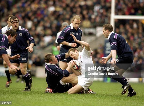 Matt Dawson of England is hauled down by Matt Stewart of Scotland during the Lloyds TSB Six Nations 2001 Championship match played at Twickenham, in...