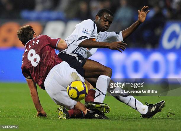 Fabrice Muamba of Bolton battles with Scott Parker of West Ham during the Barclays Premier League match between Bolton Wanderers and West Ham United...