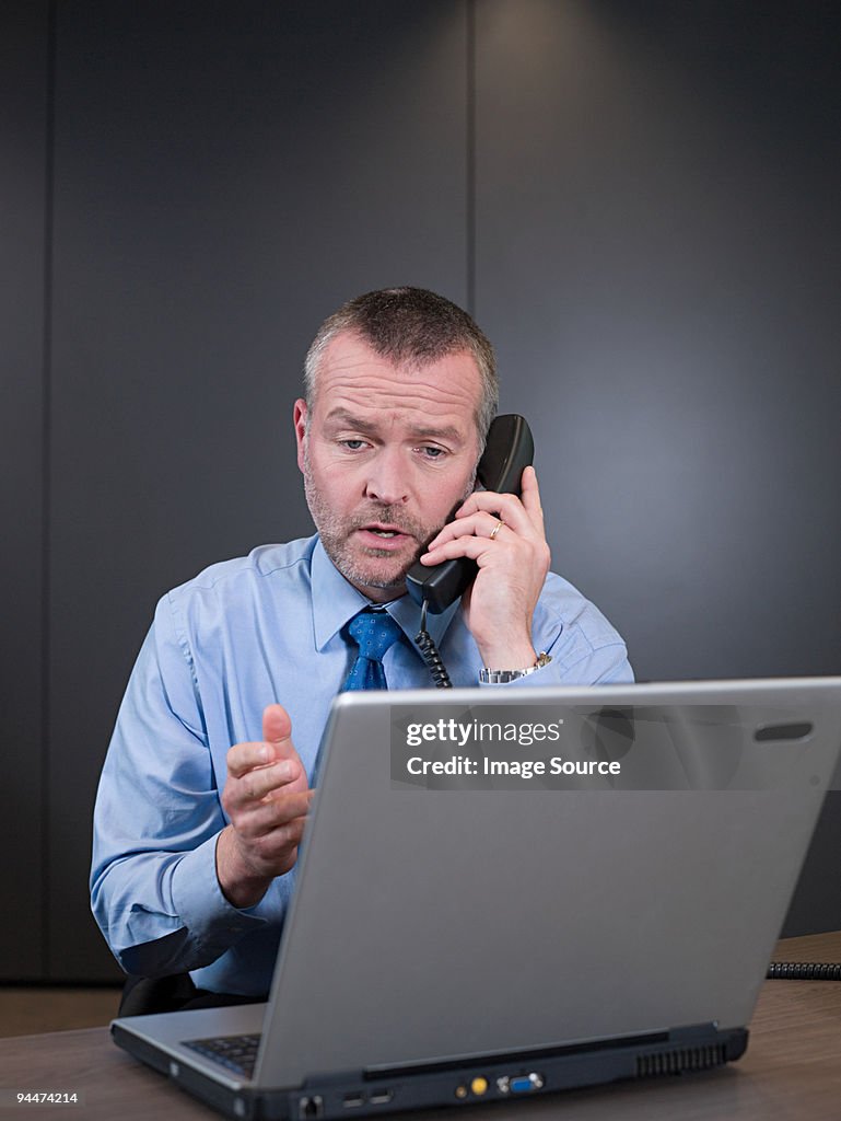 Businessman on telephone with laptop