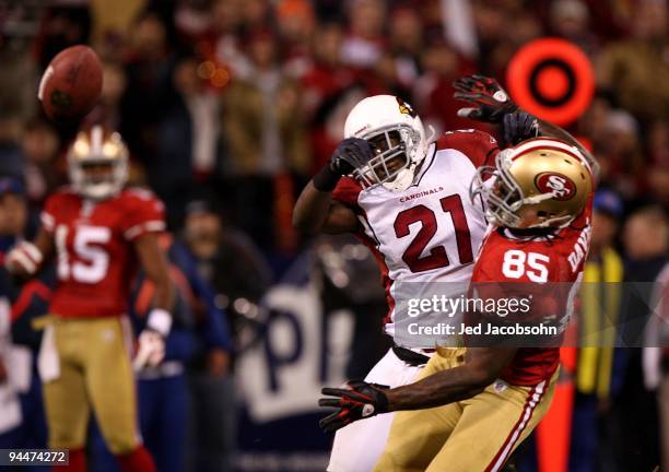 Vernon Davis of the San Francisco 49ers misses a pass as Antrel Rolle of the Arizona Cardinals defends at Candlestick Park on December 14, 2009 in...