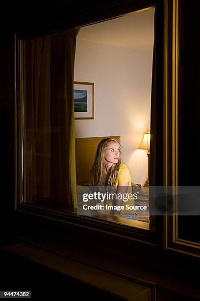 young woman in motel room - motel stockfoto's en -beelden