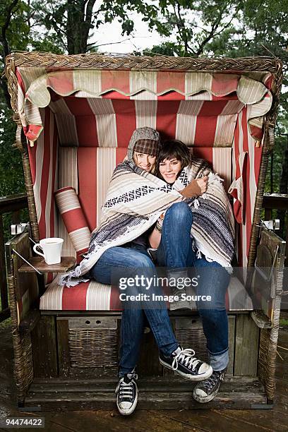 female friends in beach chair - deerstalker hat stock pictures, royalty-free photos & images