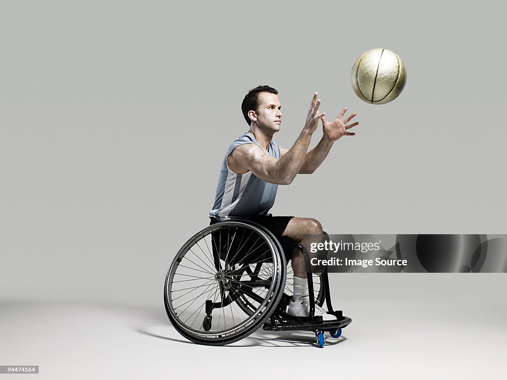 Wheelchair basketball player catching ball