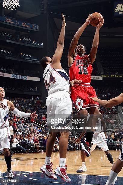 James Johnson of the Chicago Bulls goes to the basket against Jason Collins of the Atlanta Hawks during the game on December 9, 2009 at Philips Arena...