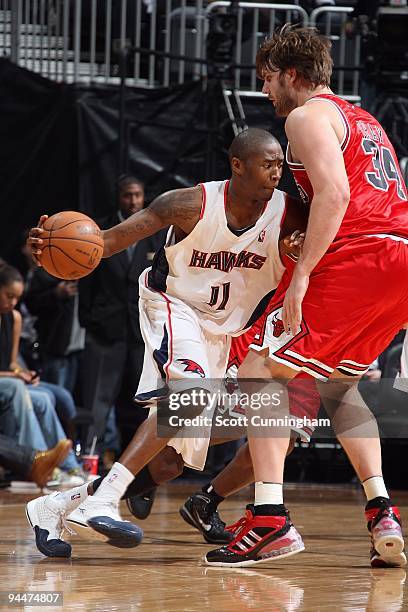 Jamal Crawford of the Atlanta Hawks drives against Aaron Gray of the Chicago Bulls during the game on December 9, 2009 at Philips Arena in Atlanta,...