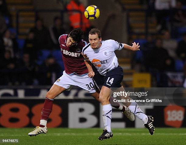 Kevin Davies of Bolton battles for the ball with Julien Faubert of West Ham during the Barclays Premier League match between Bolton Wanderers and...