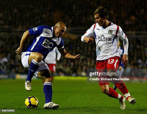 Stephen Carr of Birmingham tries to go past Morten Gamst Pederson of Blackburn during the Barclays Premier League match between Birmingham City and...