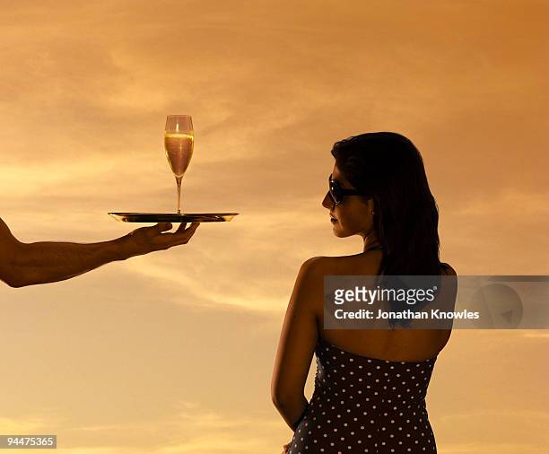 woman being served champagne - evening indulgence stock pictures, royalty-free photos & images