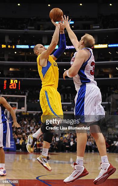 Maciej Lampe of the Maccabi Electra Tel Aviv puts a shot up against Chris Kaman of the Los Angeles Clippers battle for position during a preseason...