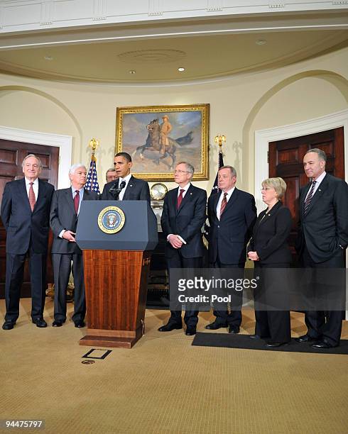 President Barack Obama speaks to the press flanked by Sen. Tom Harkin , Sen. Chris Dodd , Sen. Max Baucus , Senate Majority Leader Harry Reid , Sen....