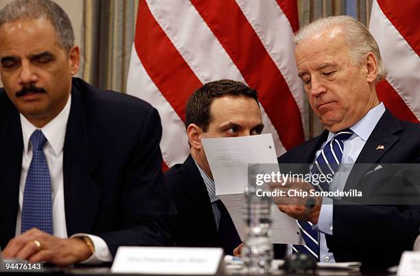 Vice President Joe Biden receives a message during a roundtable discussion about enforcing laws against the piracy of intellectual property with...