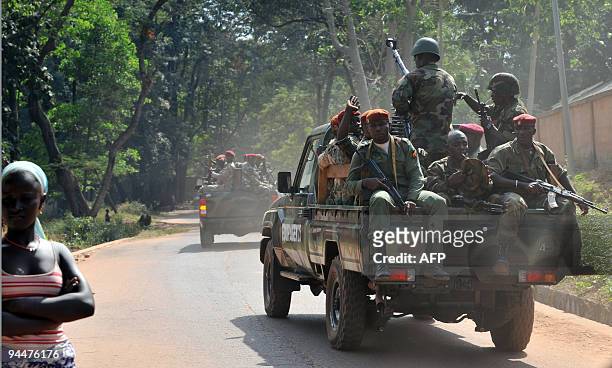 Group of soldiers standing atop of a pick-up truck escort Guinean general Sekouba Konate, interim leader after Guinea's former strongman captain...