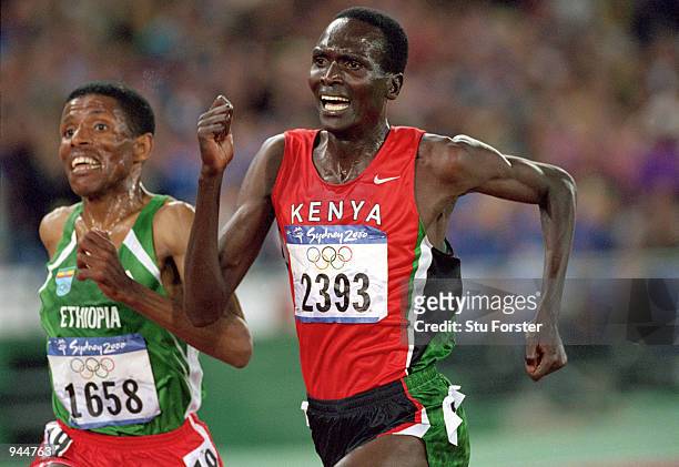 Paul Tergat of Kenya is overtaken by Haile Gebrselassie of Ethiopia down the home straight of the Mens 10000m Final at the Olympic Stadium on Day 10...