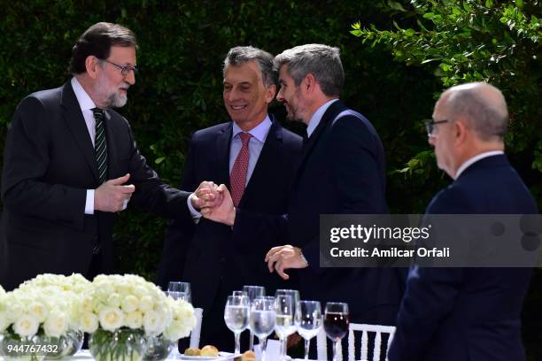 Chief of Cabinet Marcos Peña greets Prime Minister of Spain Mariano Rajoy and President of Argentina Mauricio Macri during the first day of the...