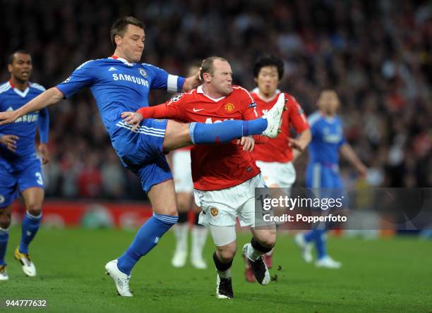 Wayne Rooney of Manchester United is stopped by John Terry of Chelsea during the UEFA Champions League Quarter-Final second leg match between...