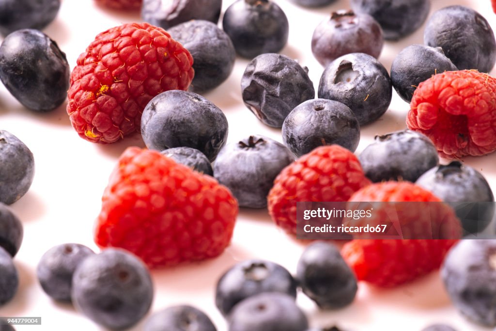 Close-Up Of Berry Fruits Against White Background