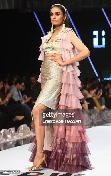 Model presents a creation by Pakistani designer Rozina Munib on the final day of the Fashion Pakistan Week Spring/Summer 2018 in Karachi on April 11,...