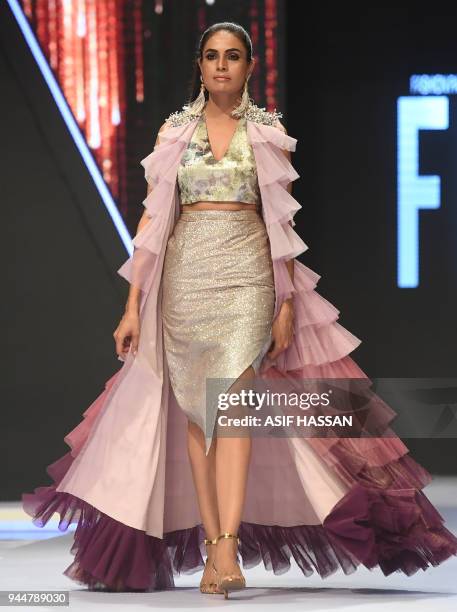 Model presents a creation by Pakistani designer Rozina Munib on the final day of the Fashion Pakistan Week Spring/Summer 2018 in Karachi on April 11,...