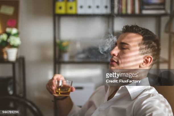 smoking and drinking in the office - alcohol and smoking stock pictures, royalty-free photos & images