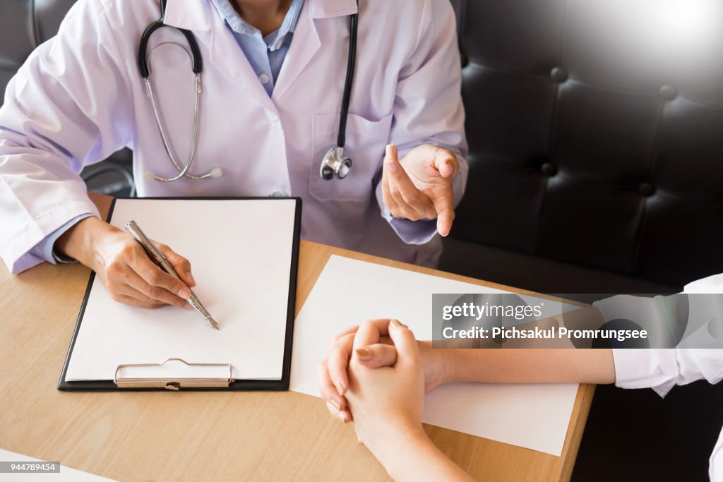 Midsection Of Doctor Examining Patient In Hospital