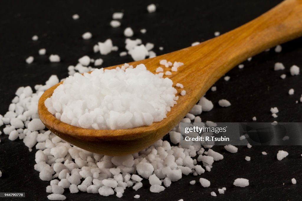 Sea salt in wooden spoon