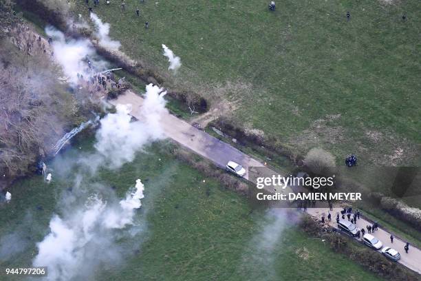 An aerial view shows a gendarmerie helicopter hovering over as gendarmes launch tear gas canisters at protesters on April 11 during a police...