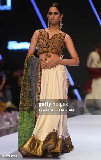 Model presents a creation by Pakistani designer Bohemi Kanwal on the final day of the Fashion Pakistan Week Spring/Summer 2018 in Karachi on April...