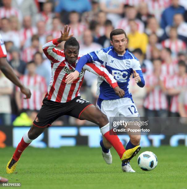 Asamoah Gyan of Sunderland and Barry Ferguson of Birmingham in action during the Barclays Premier League match between Birmingham City and Sunderland...