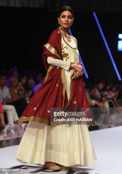 Model presents a creation by Pakistani designer Bohemi Kanwal on the final day of the Fashion Pakistan Week Spring/Summer 2018 in Karachi on April...