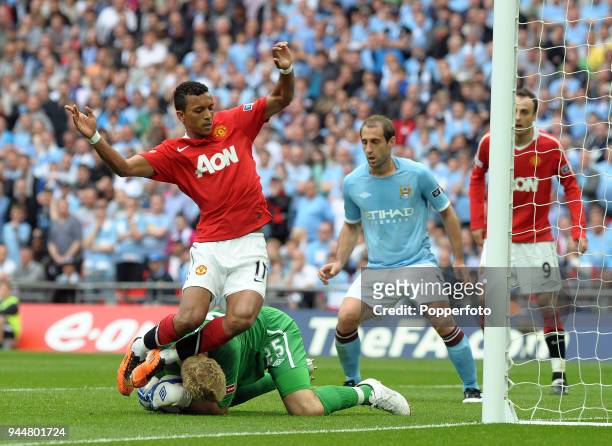 Manchester City goalkeeper Joe Hart bravely saves at the feet of Manchester United's Nani during the FA Cup sponsored by E.ON semi final match...