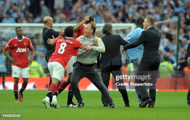 Anderson and Rio Ferdinand of Manchester United are restrained by Manchester City's Roberto Mancini and David Platt during an argument with Mario...