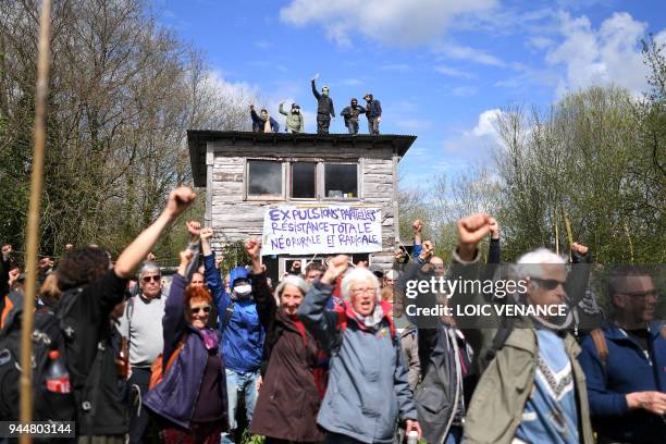 Protesters raise their fists on April 11 during a police operation to raze the decade-old anti-capitalist camp known as ZAD set up to protest a new...