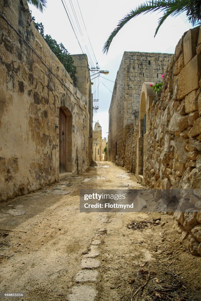 Small alley in Ghammar, Gozo, with limestone houses