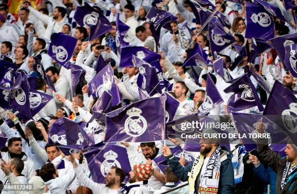 Real Madrid fans wave flags before the UEFA Champions League quarter-final second leg football match between Real Madrid CF and Juventus FC at the...