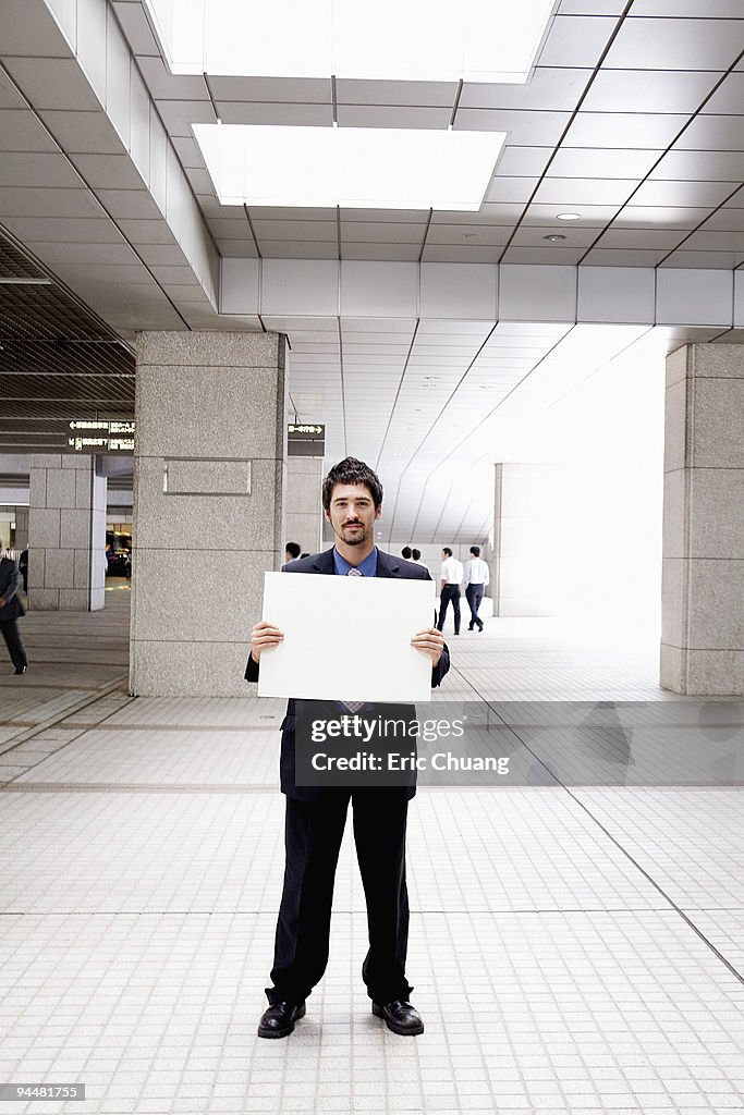 Businessman holding blank sign