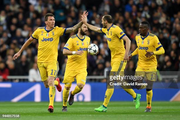 Mario Mandzukic of Juventus celebrates with teammate Giorgio Chiellini after scoring his sides first goal during the UEFA Champions League Quarter...