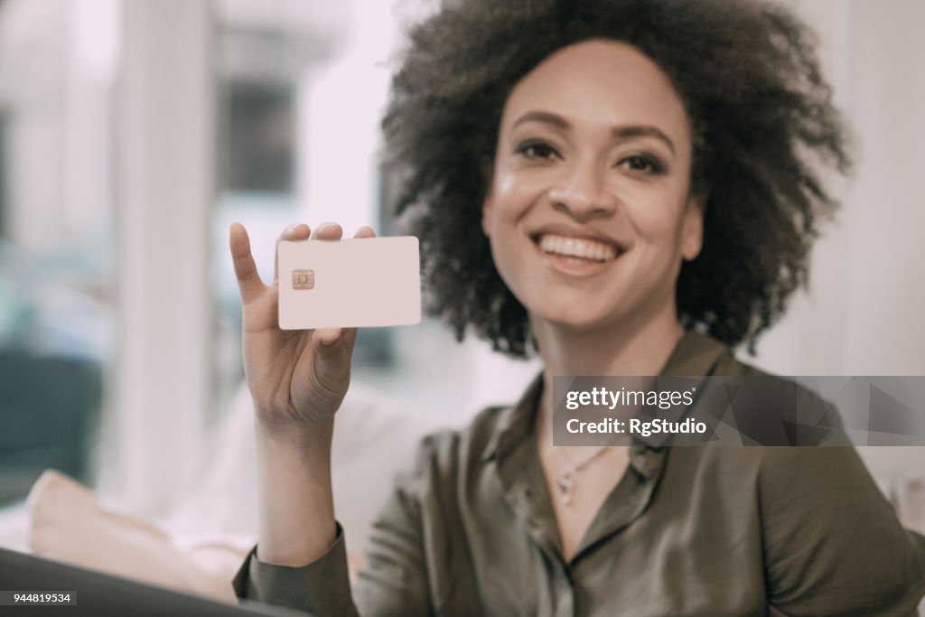 Happy woman with a credit card